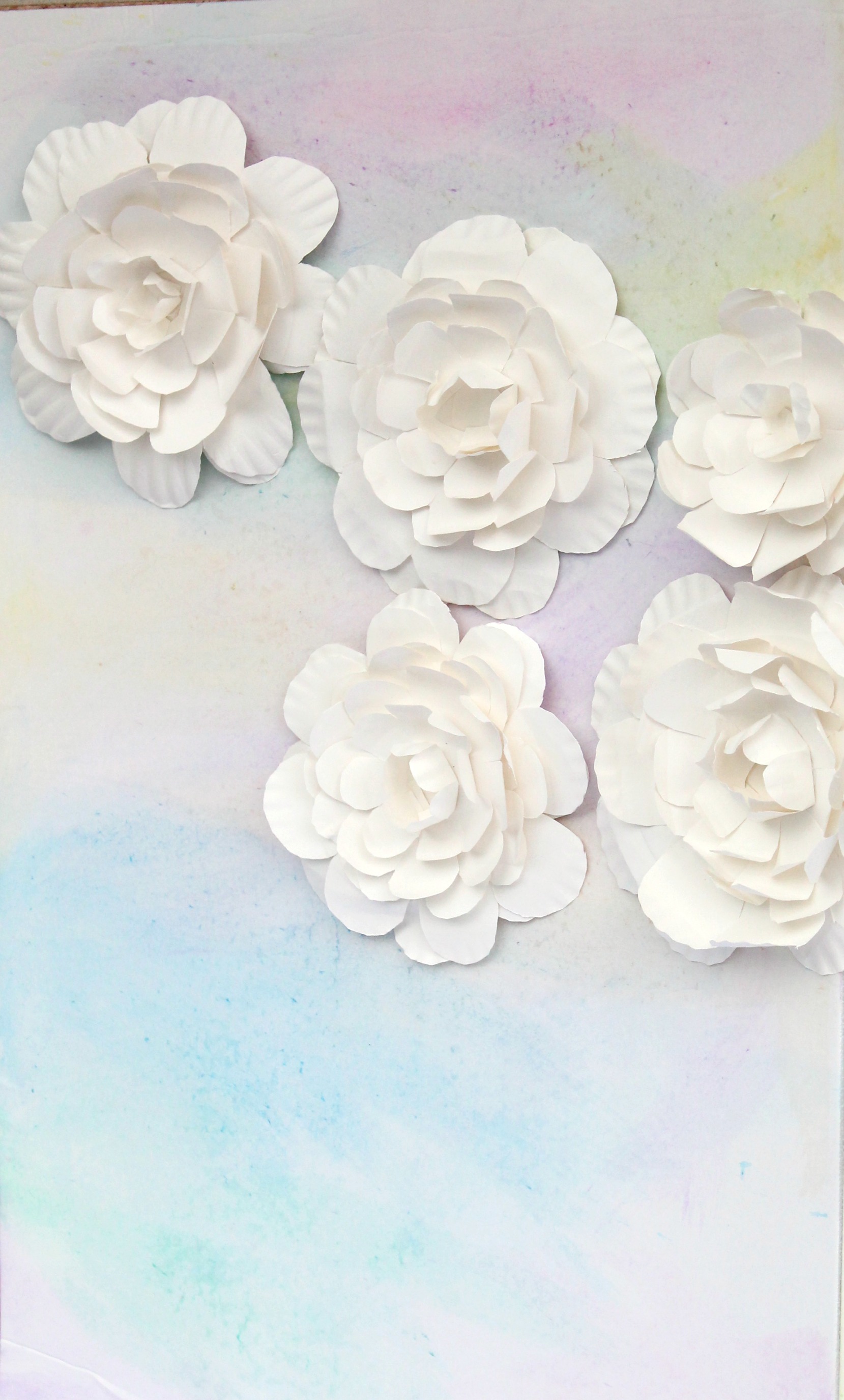 Watercolor Baby Shower Backdrop with Paper Plate Flowers by PartiesforPennies.com